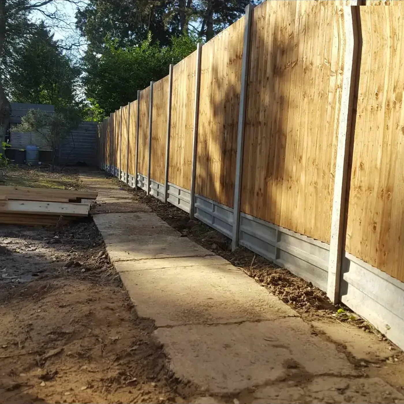 Long run of close board fencing with concrete posts and gravel boards along a Croydon garden boundary