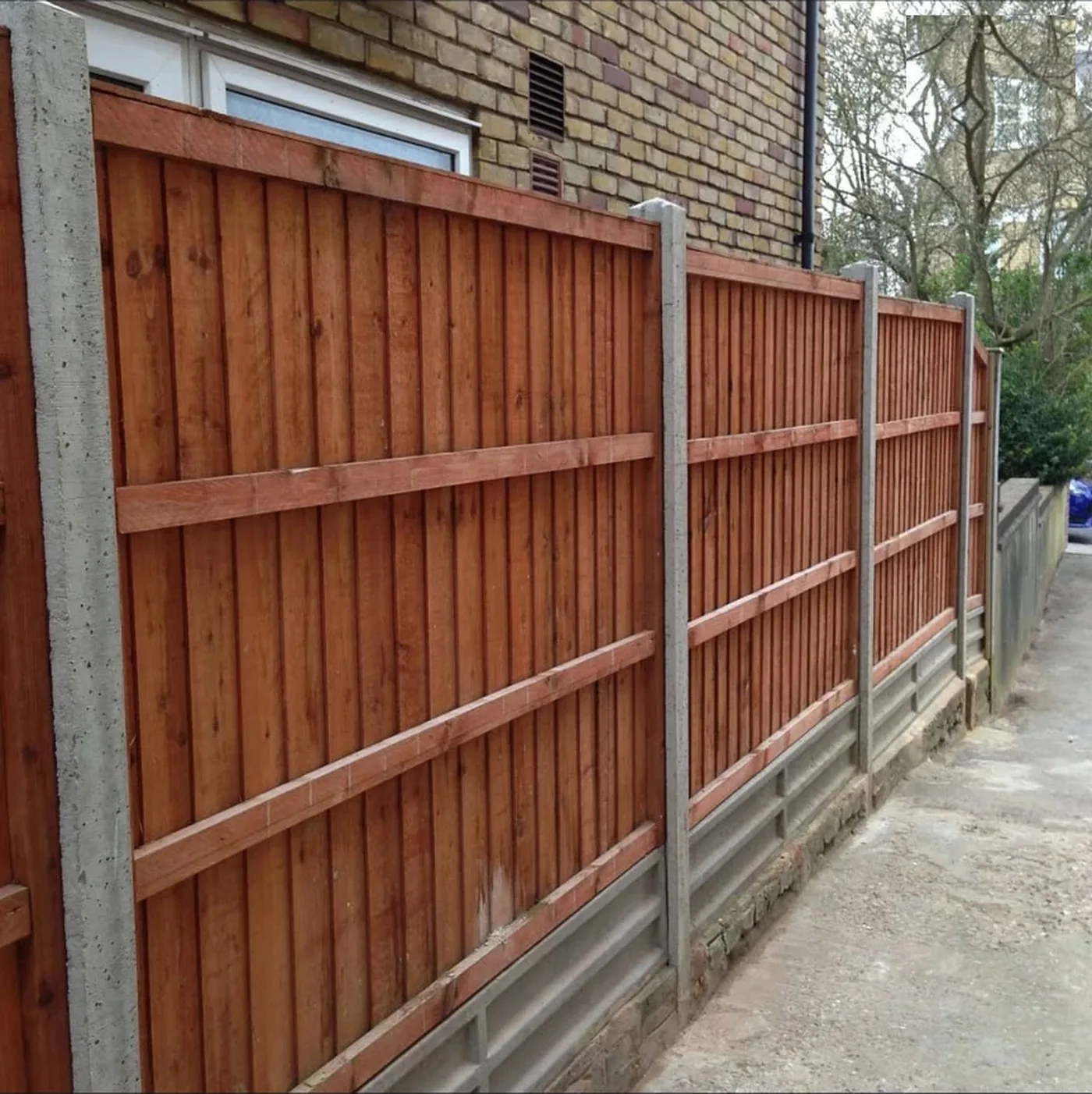 Closeboard fence panels with concrete posts and gravel boards along a side driveway in Orpington