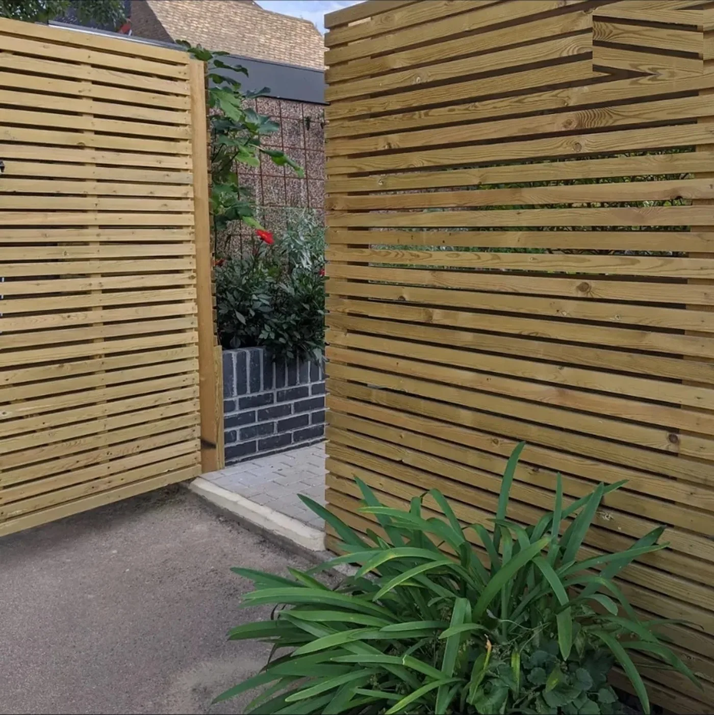 Slatted timber fence with a matching slatted side gate leading to a rear garden in Chislehurst